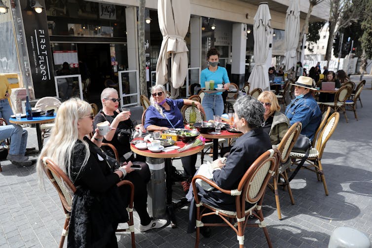 People sit in a re-opened restaurant in downtown Jerusalem.