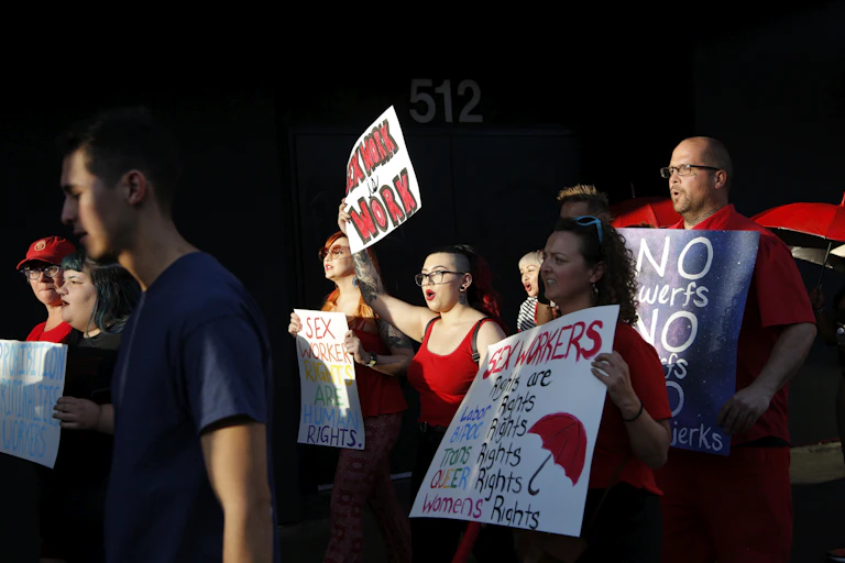 People march holding signs