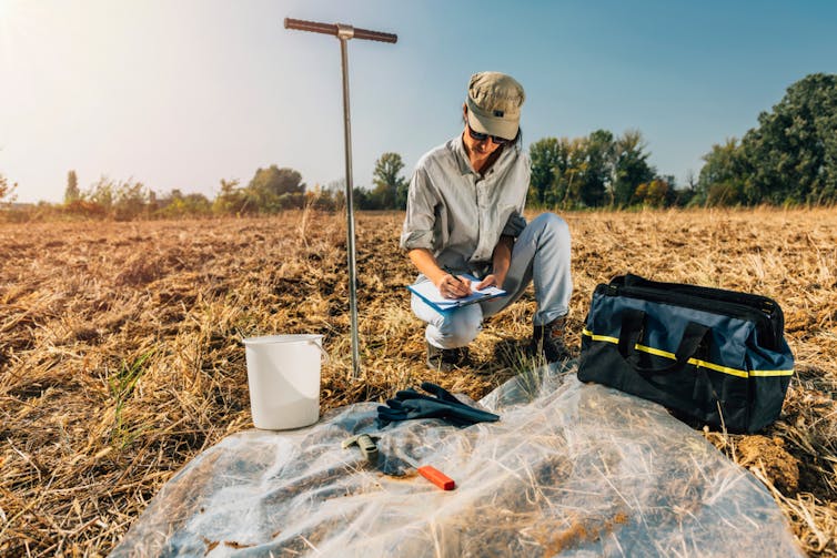 young woman conducting soil testing