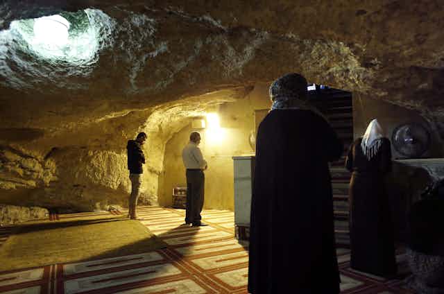 Muslims praying at the Mihrab, a niche in a wall indicating the direction of the Kaaba in Mecca, at the Foundation Stone, located under the Dome of the Rock in the al- Aqsa mosque compound in Jerusalem's Old City.