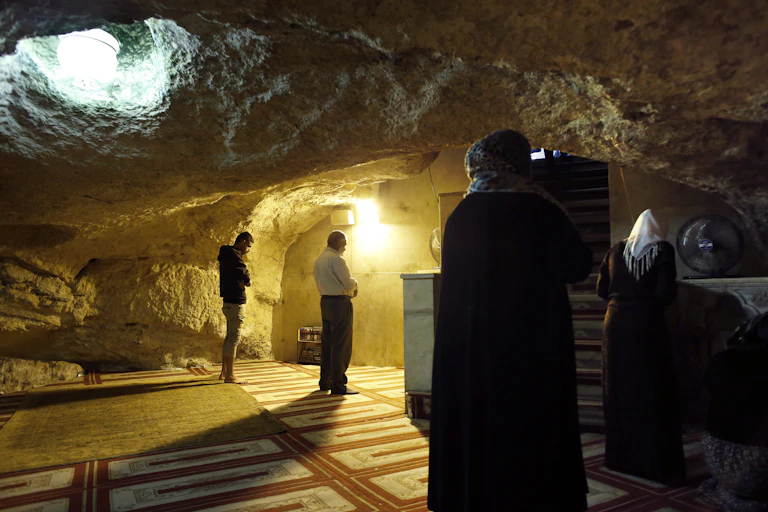 Muslims praying at the Mihrab, a niche in a wall indicating the direction of the Kaaba in Mecca, at the Foundation Stone, located under the Dome of the Rock in the al- Aqsa mosque compound in Jerusalem's Old City.