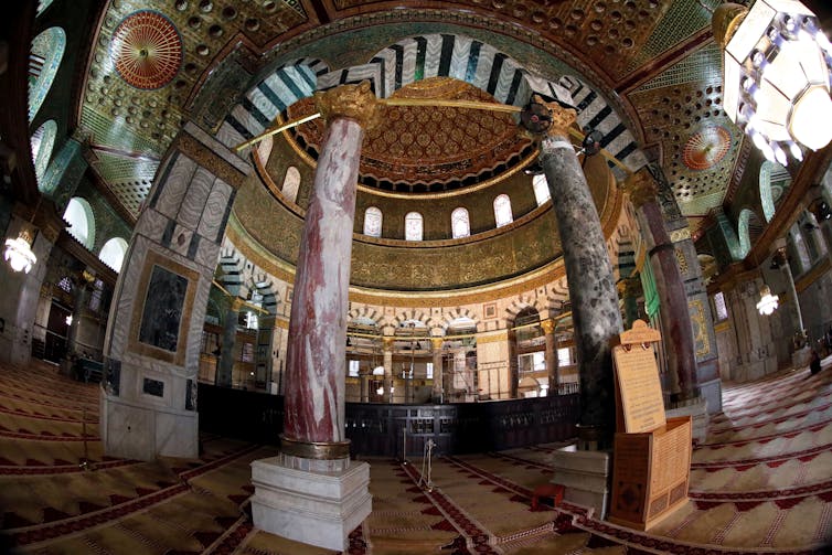 A golden dome and columns decorated by elaborate byzantine decorations.