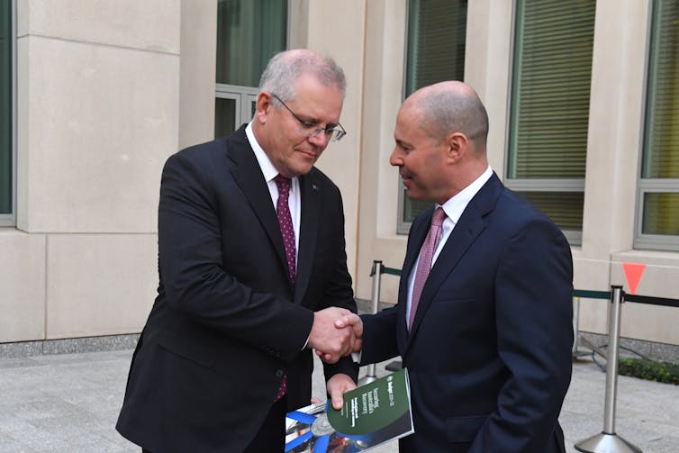 Prime Minister Scott Morrison, left, and Treasurer Josh Frydenberg shake hands