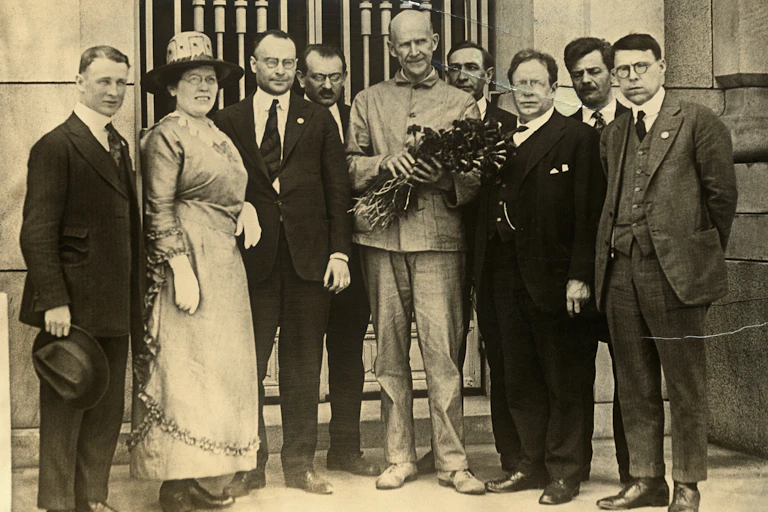 Eight socialist delegates standing with imprisoned Eugene Debs, after notifying him he had been nominated for the presidency on the socialist ticket.