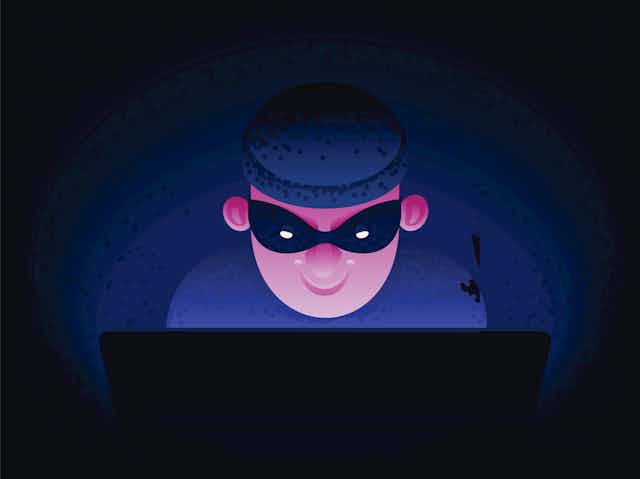 cartoon image of a man wearing a dark knit cap and a mask over his eyes grinning as he uses a laptop