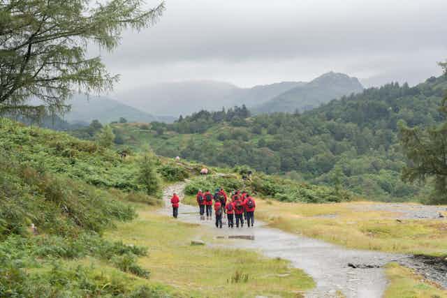A group of school students walk through a northern English landscape