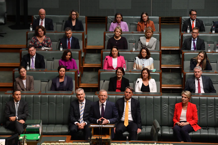 Anthony Albanese delivering his 2021 budget reply in the House of Representatives, with fellow MP's sitting behind him