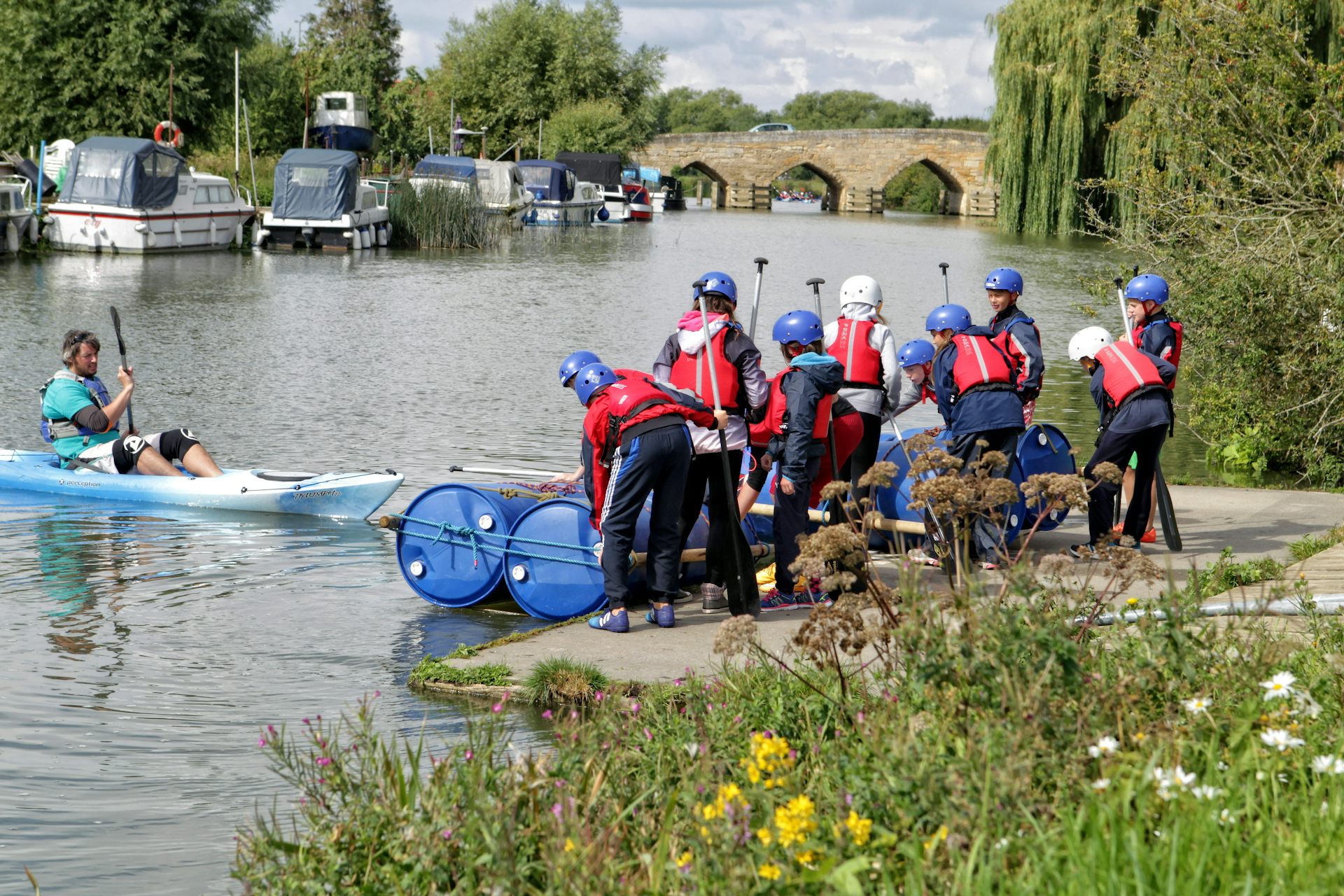 A group of school children learn about kayaking on the Thames in Oxfordshire
