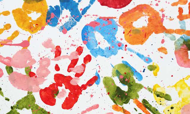 Handprints in paint on a paper.