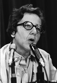 A woman at a microphone.