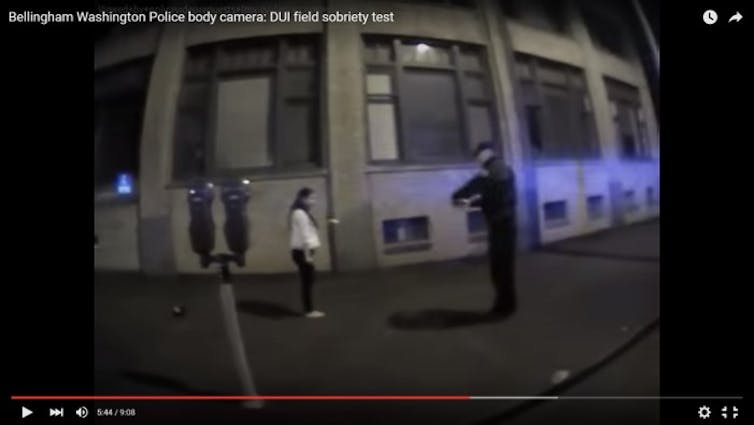 A police officer gives a field sobriety test to a person