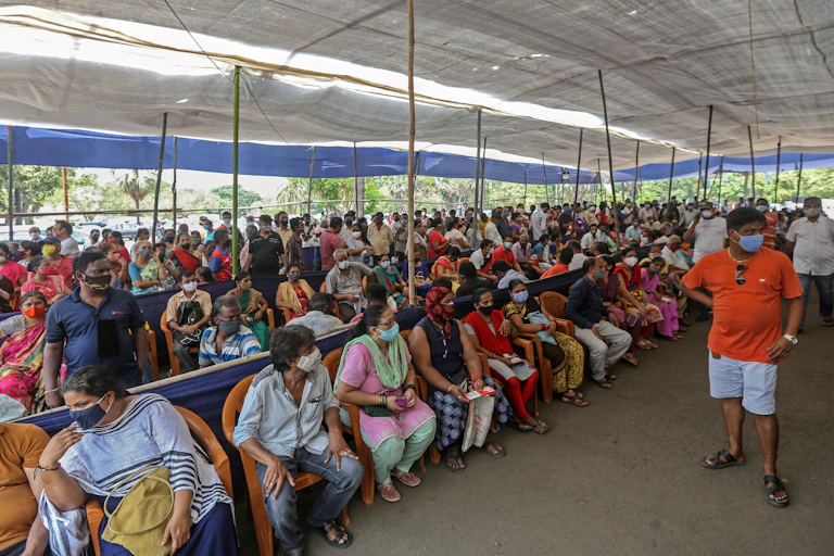 People sitting down waiting for covid vaccine.