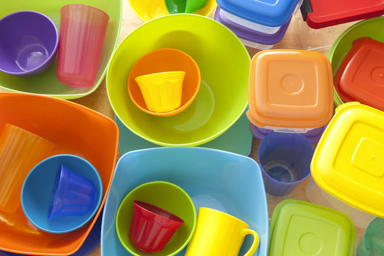 A pile of plastic dinnerware and storage containers