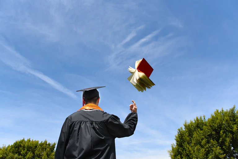 Academic seen from behind as he tosses away a book