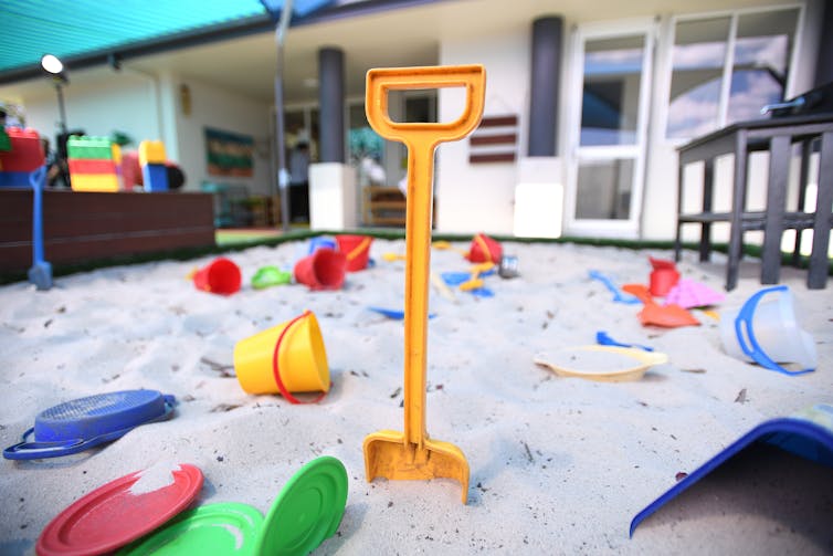 A sandpit with plastic toys (buckets and spades)