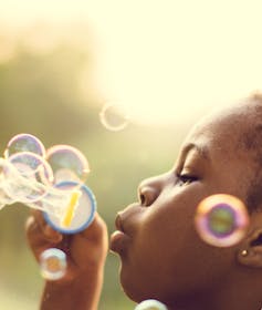 Girl blowing bubbles.