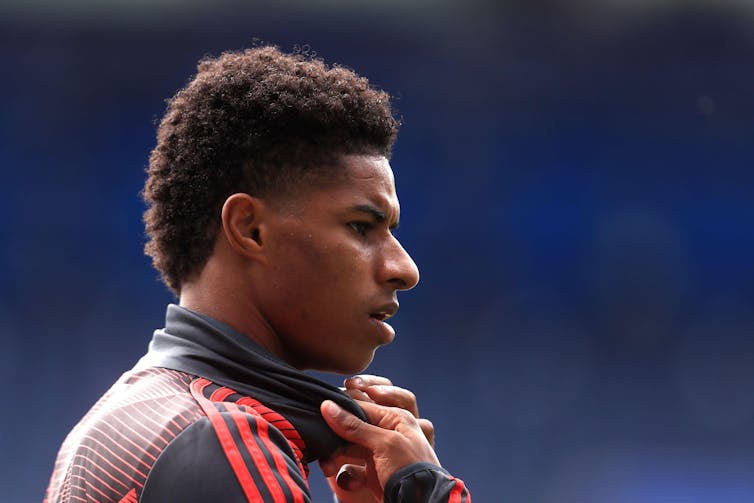 A close-up profile shot of Man U striker Marcus Rashford in training kit