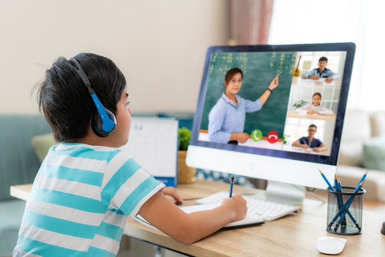 Boy learning from teaching on Zoom screen.