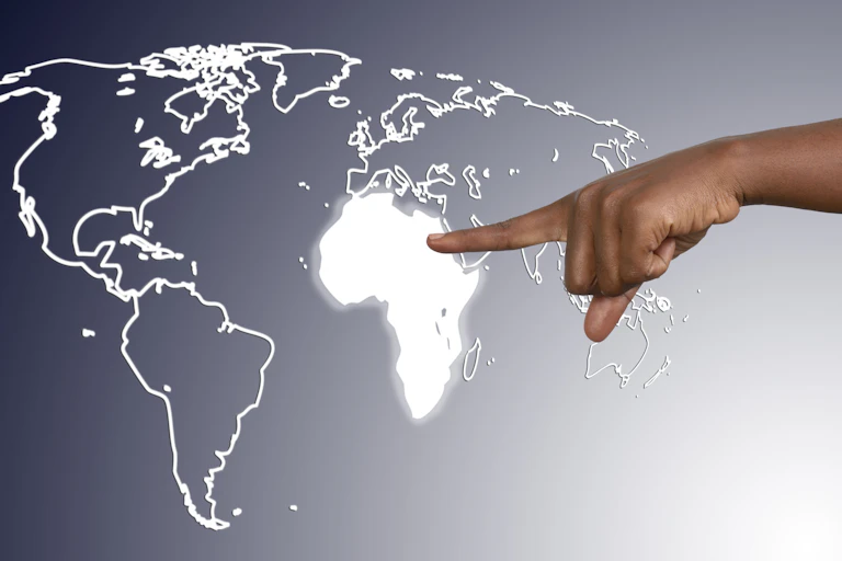 Finger pointing to map of the world with Africa highlighted