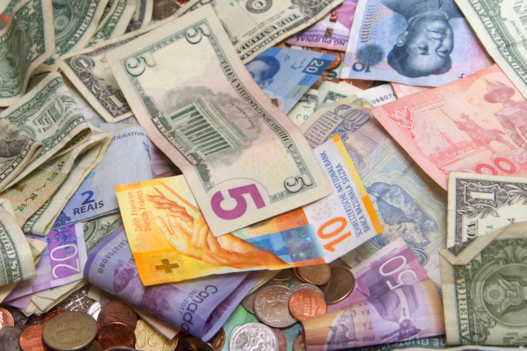 Collection of bank notes and coins from around the world.
