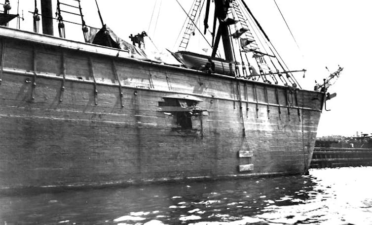 A black and white photo of a ship with a hole in it