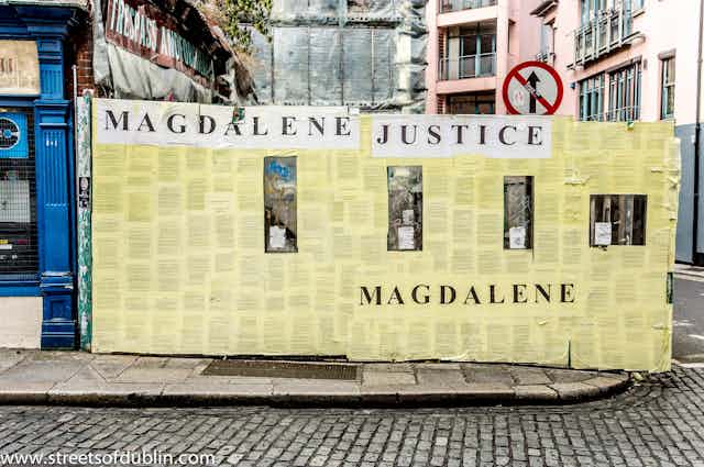 A yellow hoarding in Dublin protesting for justice for women who were victims of the notorious Magdalene Laundries.