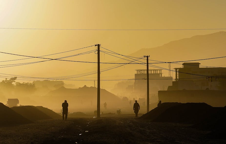 Two men in silhouette in the early morning in Kabul