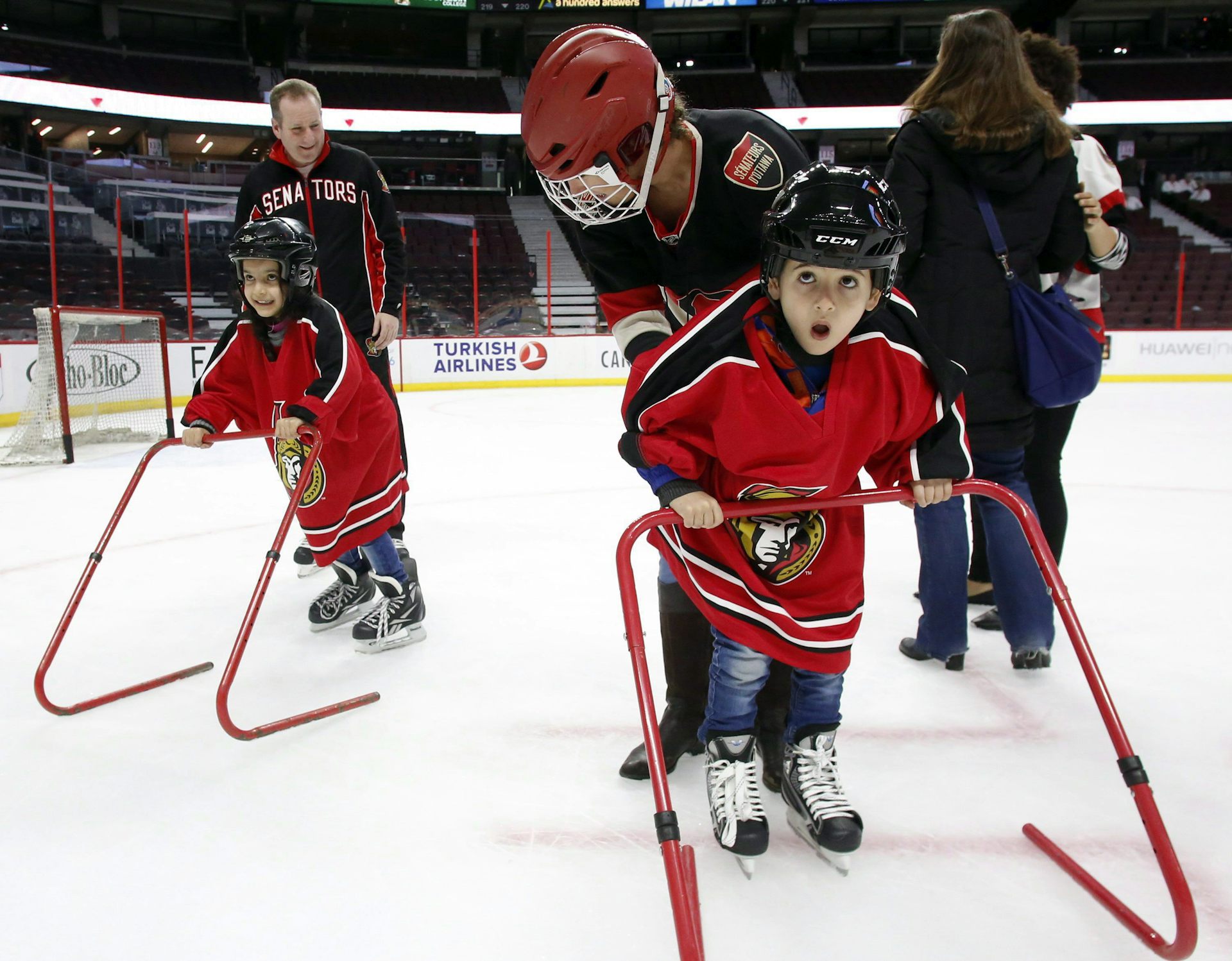 Young refugee children learn to skate.