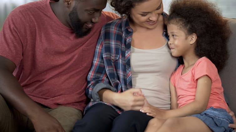 A man and a woman with a child