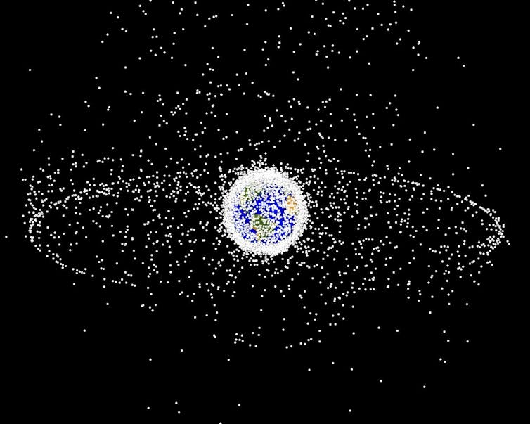 An image of the Earth surrounded by a cloud of yellow dots.