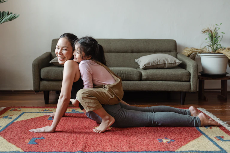 A woman doing yoga with a child