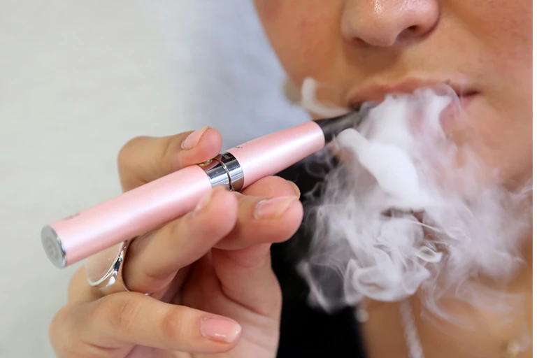 Close-up of someone smoking e-cigarette