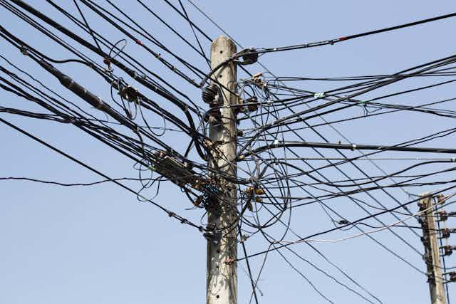 An electricity post with many wires connected to is as a result of illegal electricity connections.