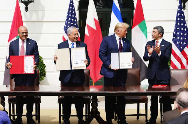 The leaders and foreign ministers of Bahrain, Israel, USA and UAE holding up signed copies of the Abraham Accords, August 2020.