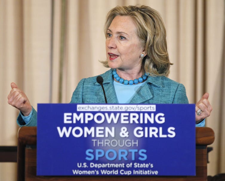 Hillary Clinton stands behind a lectern to deliver a speech.