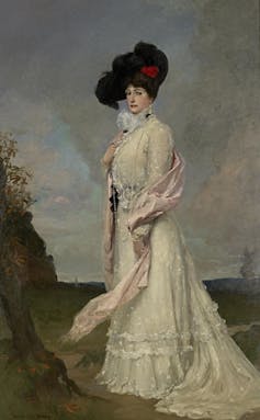 Full length portrait, Melba in a long white dress and big black hat.