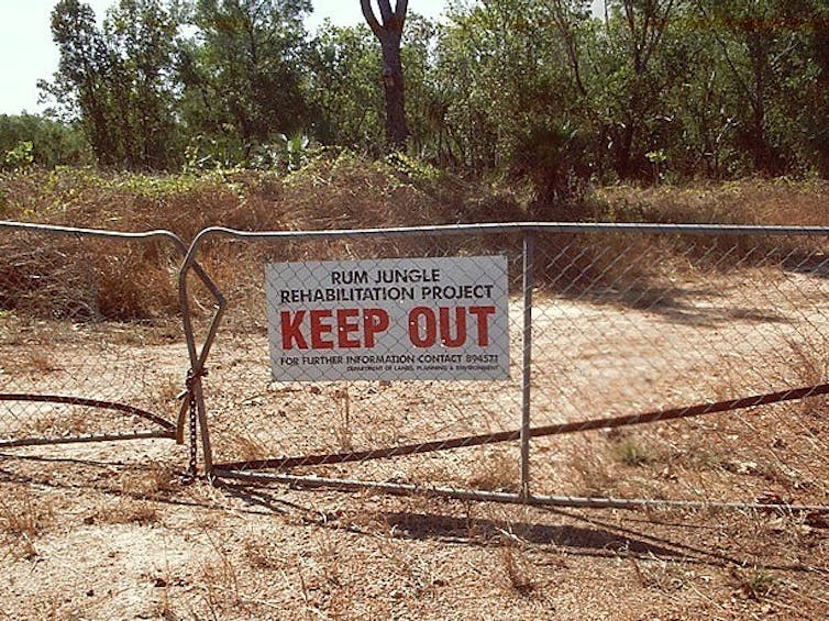 A sign for Rum Jungle rehabilitation on a fence
