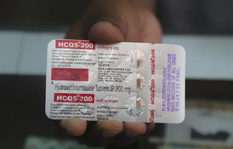 Someone holding a packet of hydroxychloroquine
