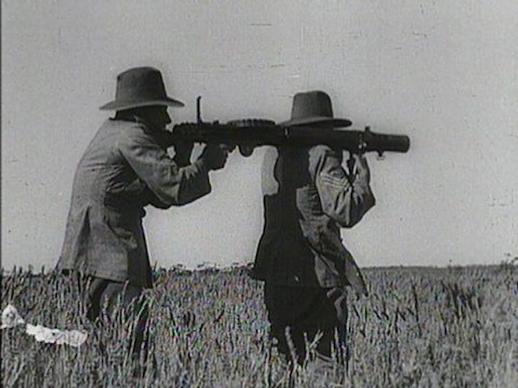 Two soldiers from 1930s with guns