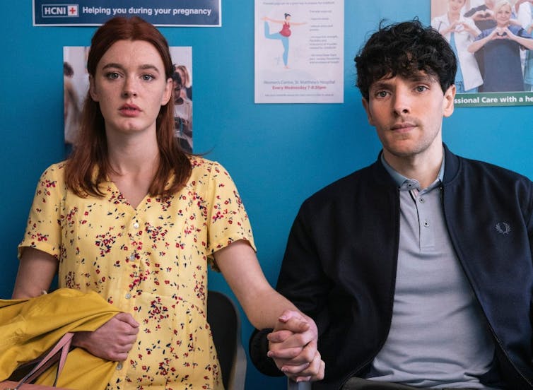 A couple waiting in a hospital waiting room.