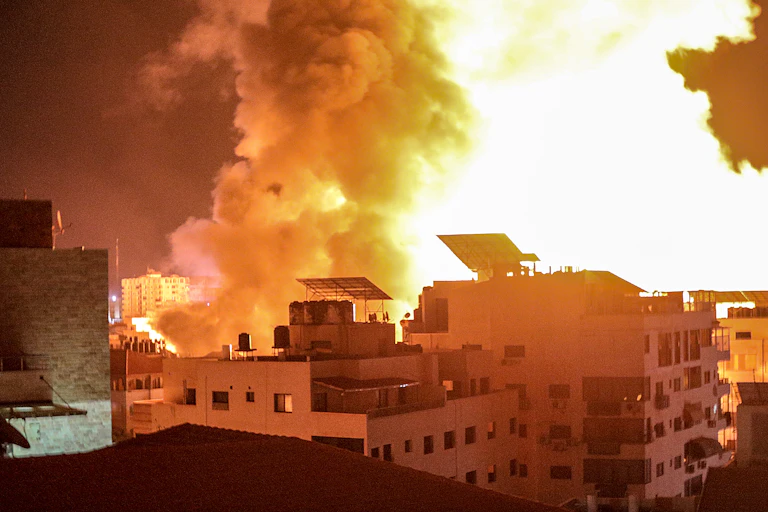 Flames and smoke over the Gaza City skyline during an airstrike by Israeli aircraft.