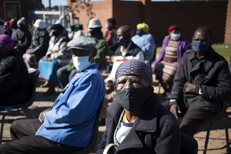 Members of the community wait in line to receive their vaccination in Johannesburg.