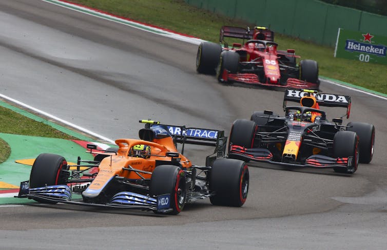 Three Formular 1 cars race.