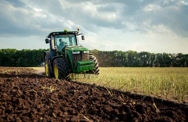 A tractor ploughing a field.