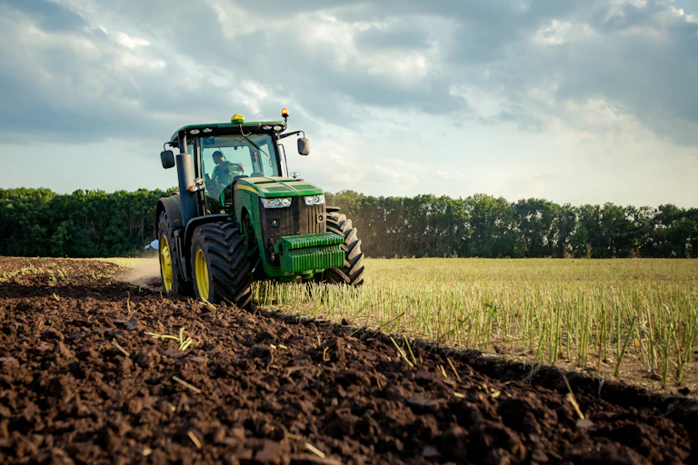 A tractor ploughing a field.