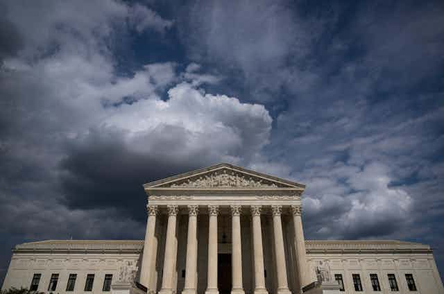 Photo of the Supreme Court building with ominous clouds overhead