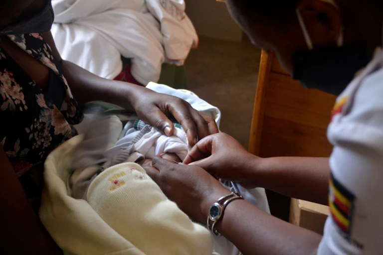 Mother holding a child getting an injection.