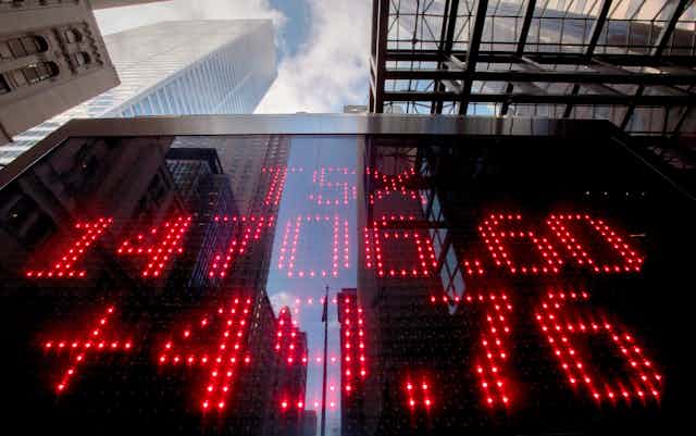 A sign board in Toronto's financial district shows the TSX market value and gain 