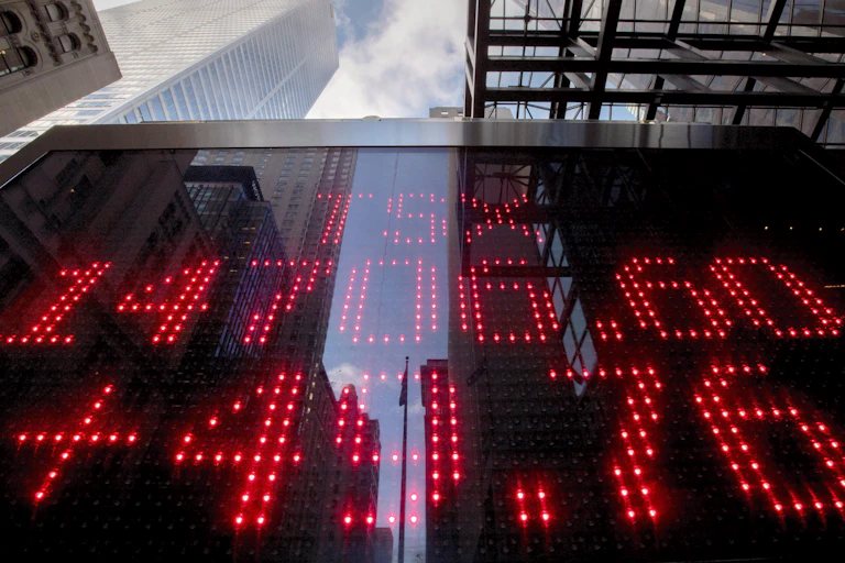 A sign board in Toronto's financial district shows the TSX market value and gain