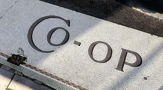 A floor mosaic reads 'co-op'